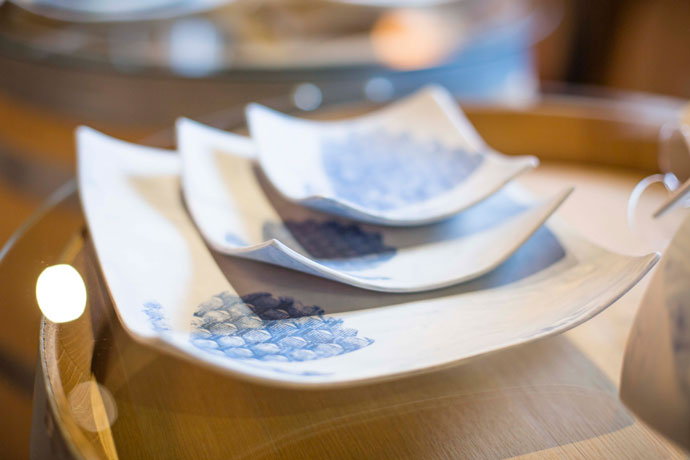 Ineke Nicolle, porcelain with printed Protea from shweshwe material