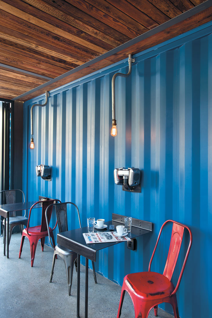 The corrugated interior container walls were left unpainted, Neil found the 1950s Bakelite chairs in France, and the light fittings are from Smiley’s Restorations in Cape Town. The wall-mounted table tops were custom-made by Securen in Pretoria. 
