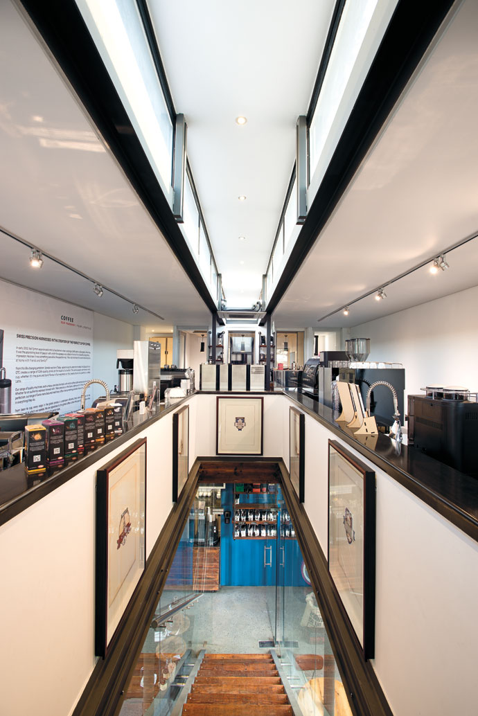 The hi-tech look of the upstairs showrooms and offices is in direct counterpoint to the concrete floor and reclaimed ceilings that preside over the coffee shop on the lower level. The art on the walls is an evolution of the Foghound logo and the hand-drawn watercolour sketches are by Hein Botha.  