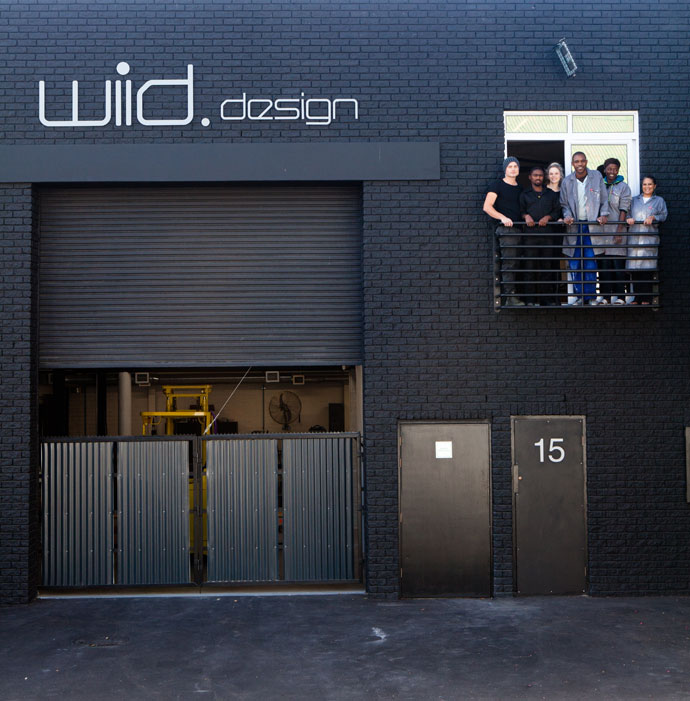 Laurie, Elsje and the EB team pose on a narrow first-floor balcony. 