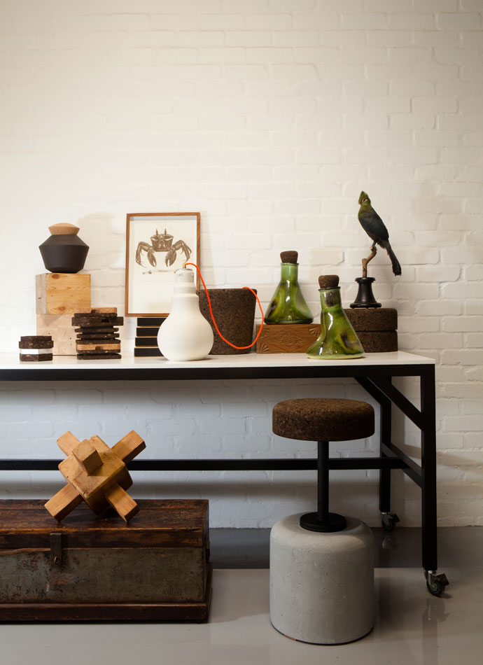 Among the Wiid Design pieces on the table are an etching by S Pratt and green lab vases by Ceramic Matters. The timber sculpture on the floor was inspired by Ethiopian jewellery. 